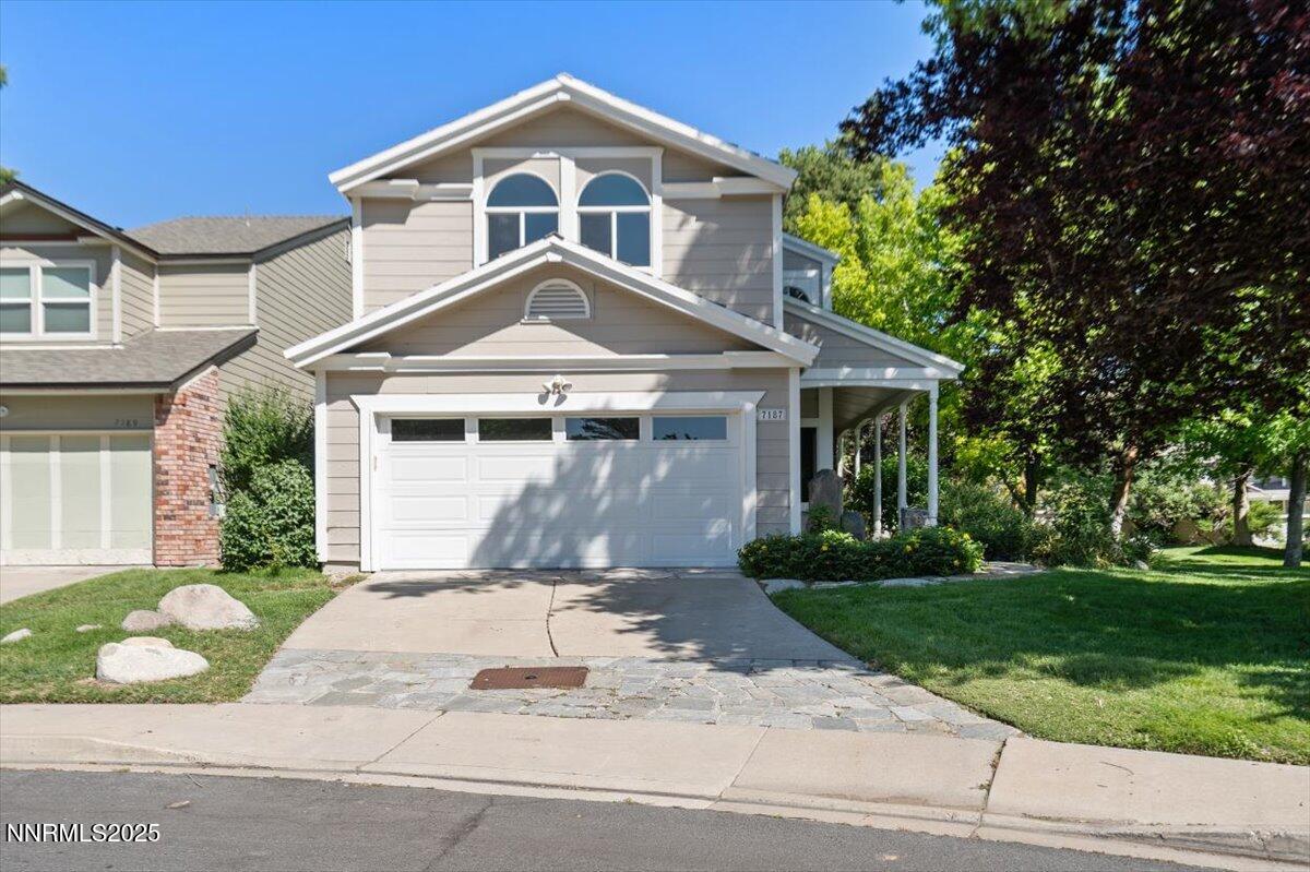 7187 Blue Falls Circle Reno, NV 89511 - Photo 3 of 42 a front view of a house with a yard