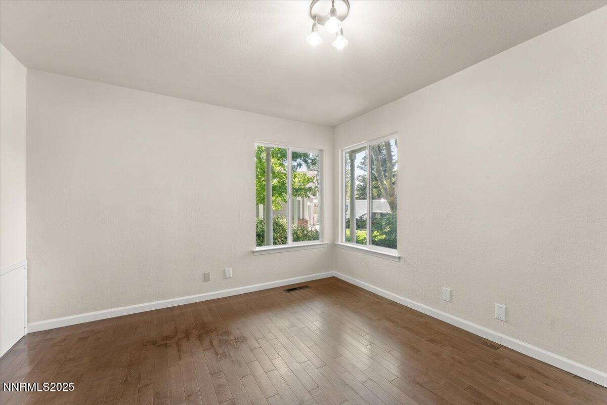 7187 Blue Falls Circle Reno, NV 89511 - Photo 33 of 42 an empty room with wooden floor and windows