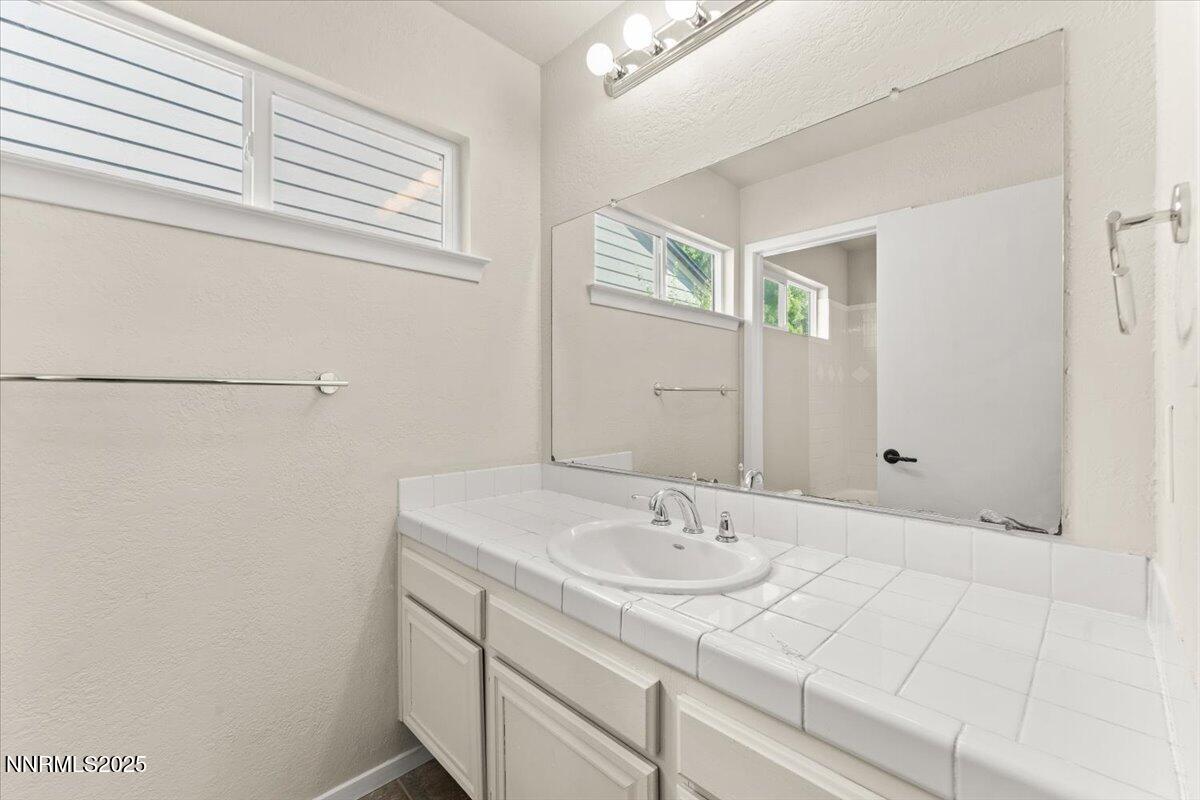 7187 Blue Falls Circle Reno, NV 89511 - Photo 35 of 42 a bathroom with a sink and a mirror