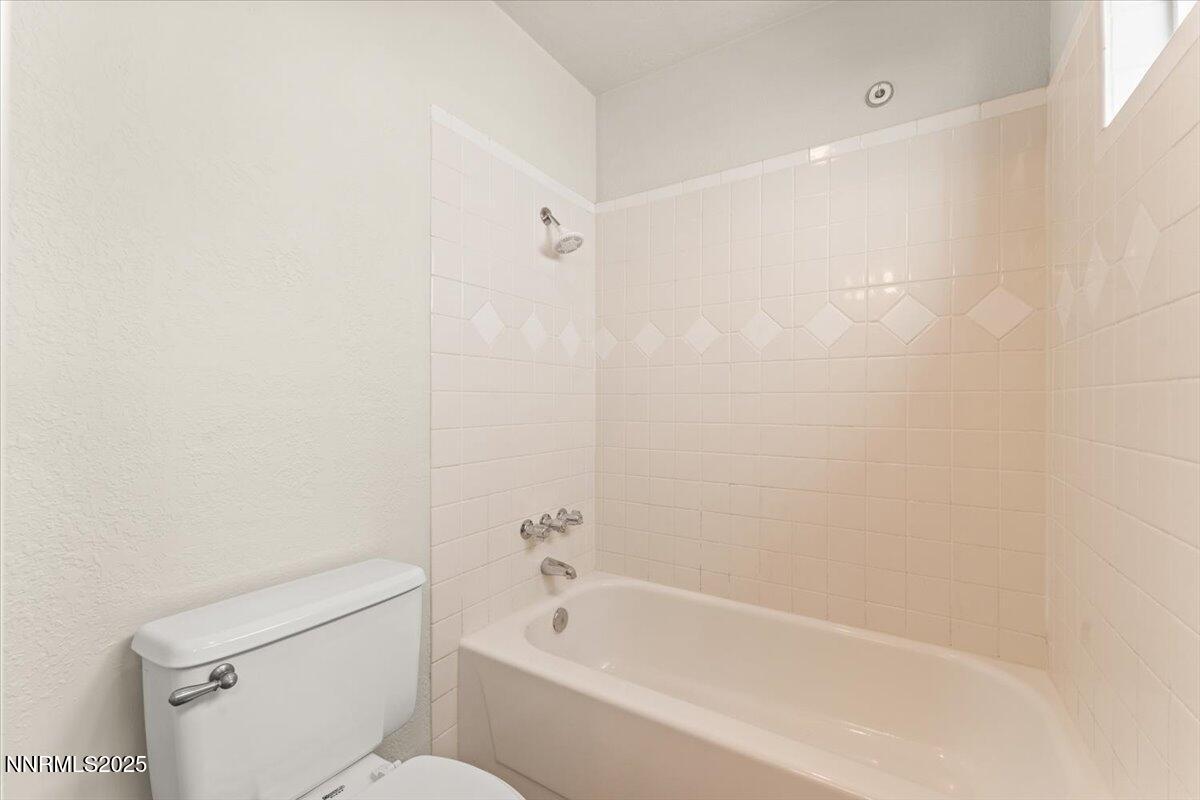 7187 Blue Falls Circle Reno, NV 89511 - Photo 36 of 42 a white bath tub sitting next to a white toilet