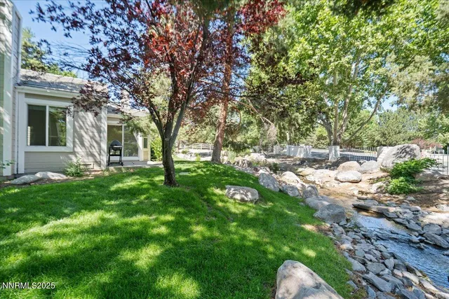 a view of backyard with outdoor seating and green space