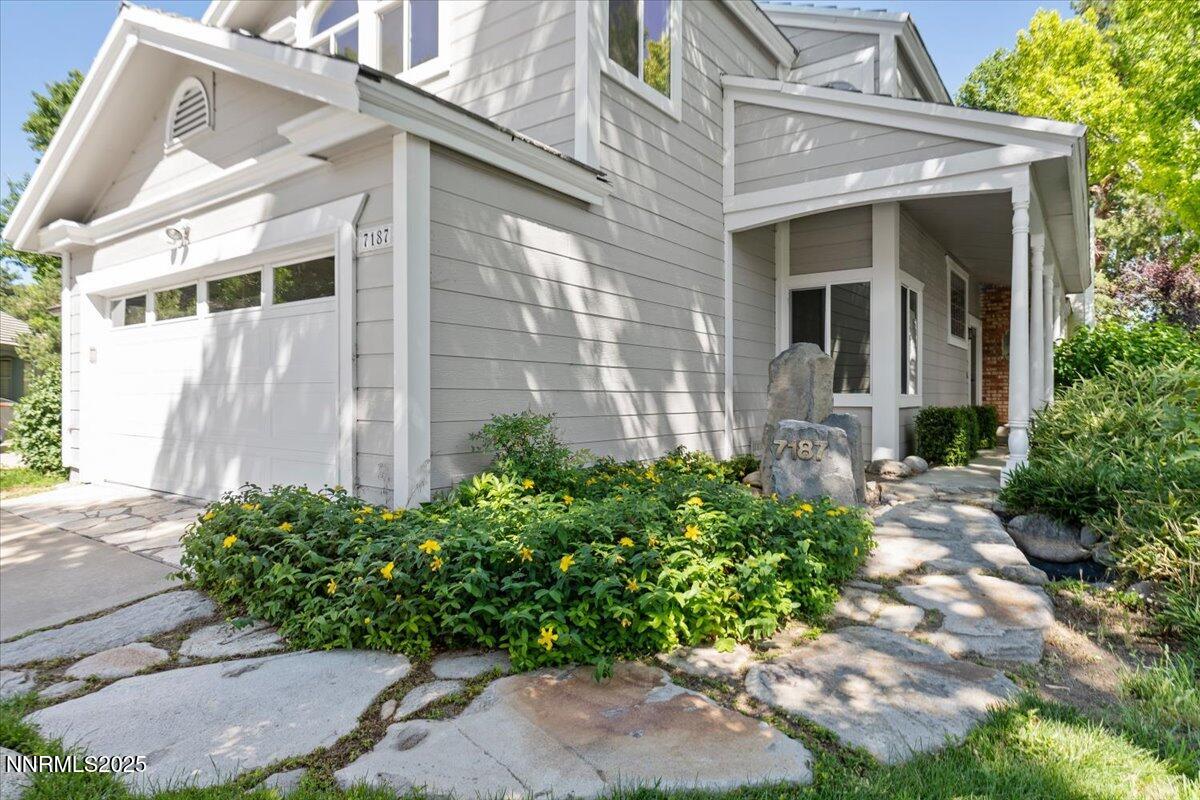 7187 Blue Falls Circle Reno, NV 89511 - Photo 4 of 42 a front view of a house with garden