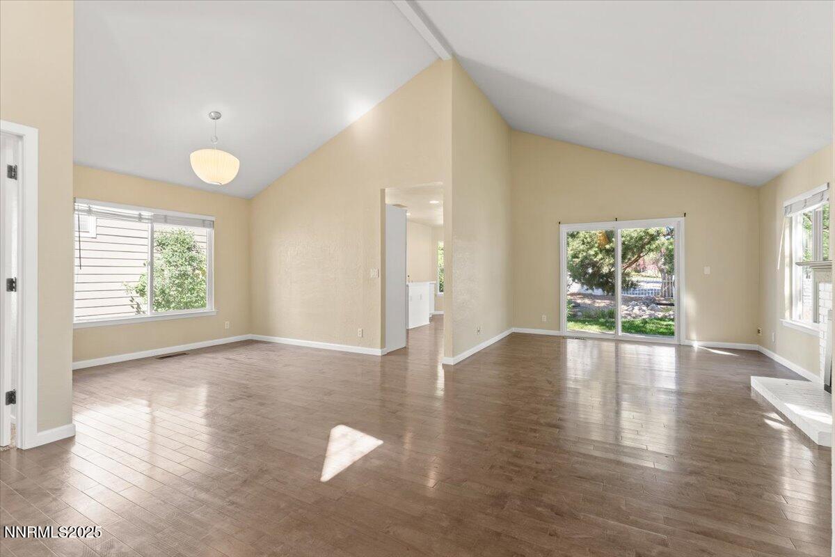 7187 Blue Falls Circle Reno, NV 89511 - Photo 7 of 42 a view of an empty room with wooden floor and a window