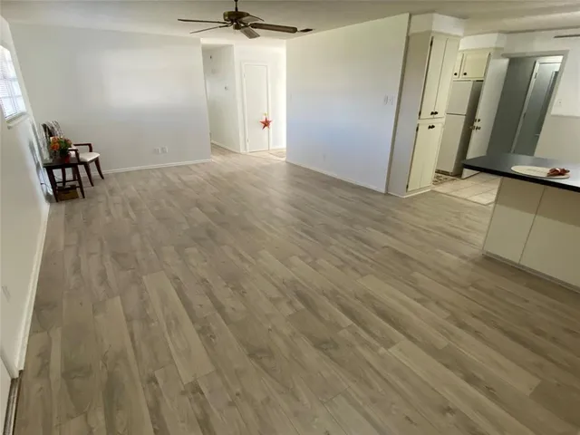 a kitchen with stainless steel appliances granite countertop a sink window and cabinets