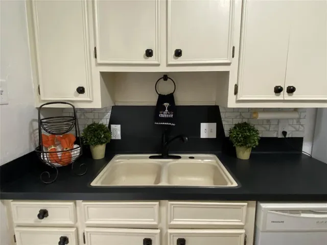 a kitchen with a sink and cabinets