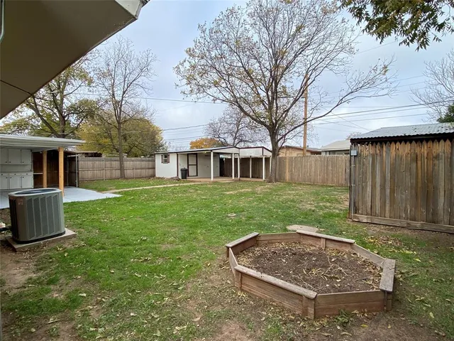 a view of a yard with a house and a garden