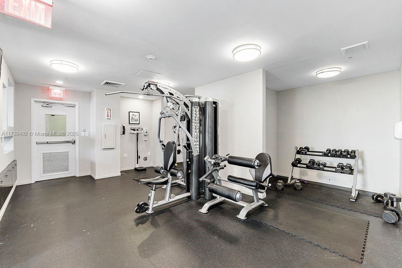 9055 Southwest 73rd Court, Unit 903 Miami, FL 33156 - Photo 12 of 24 a view of a room with gym equipment