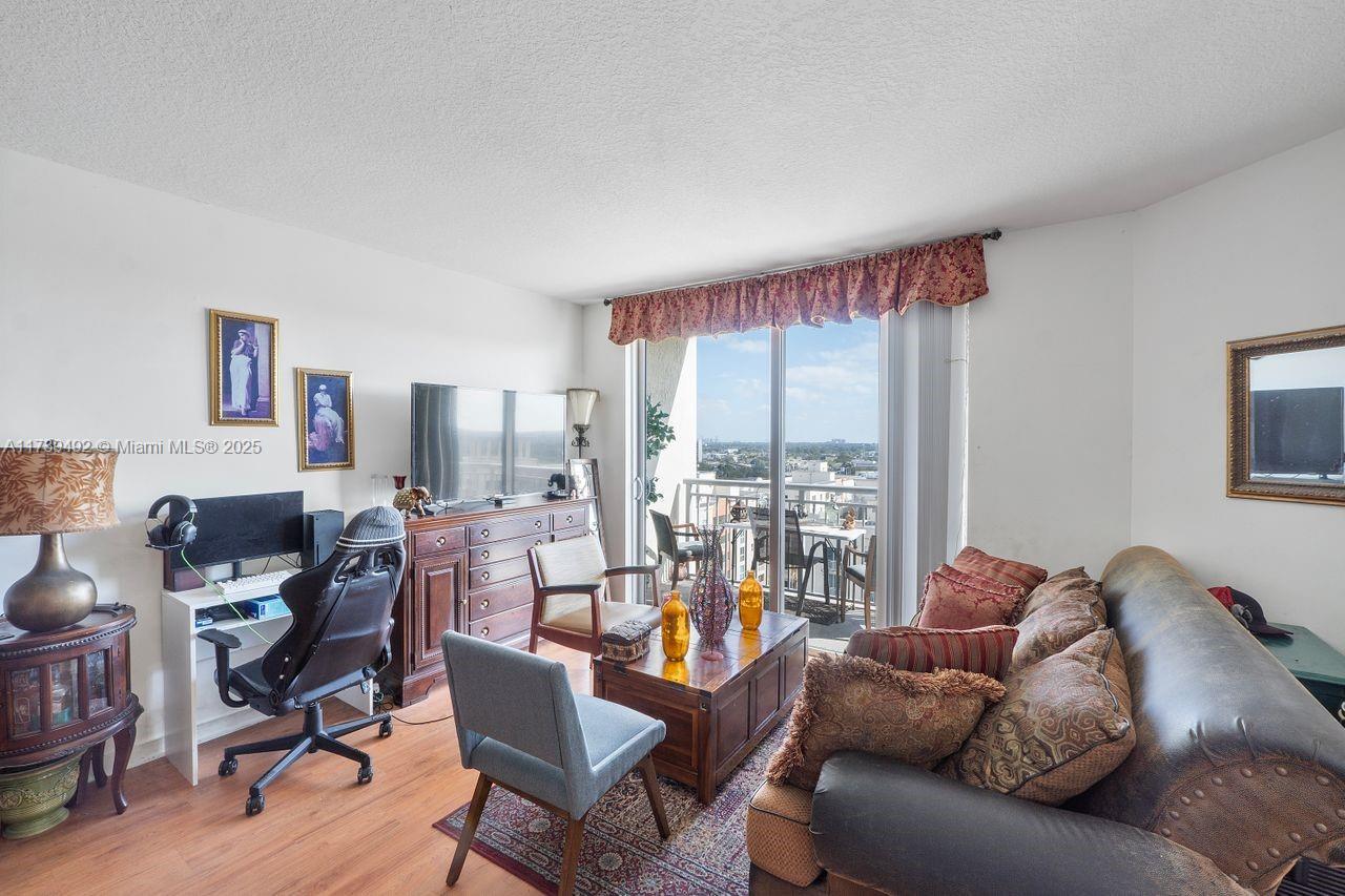 9055 Southwest 73rd Court, Unit 903 Miami, FL 33156 - Photo 16 of 24 a living room with furniture and a large window