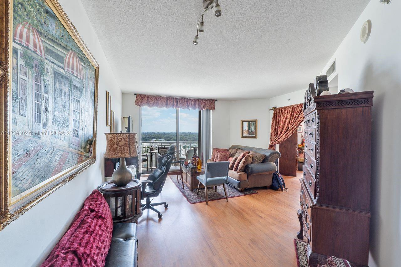 9055 Southwest 73rd Court, Unit 903 Miami, FL 33156 - Photo 17 of 24 a living room with furniture and a window