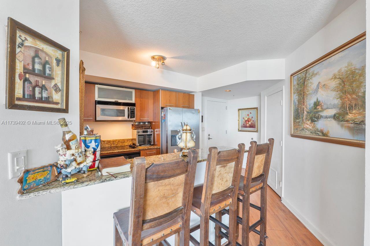 9055 Southwest 73rd Court, Unit 903 Miami, FL 33156 - Photo 18 of 24 a living room with furniture a flat screen tv and a window