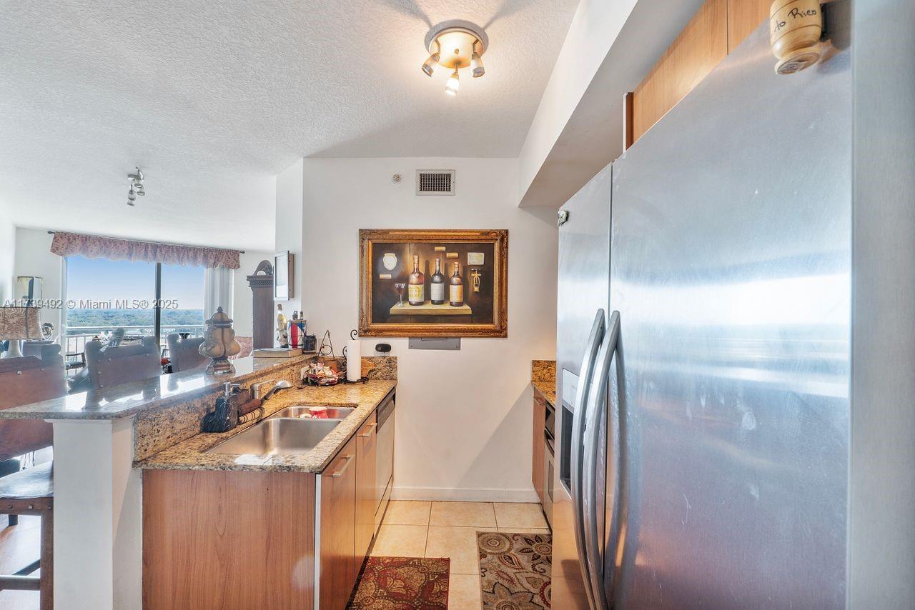 9055 Southwest 73rd Court, Unit 903 Miami, FL 33156 - Photo 19 of 24 a view of living room with furniture and a floor to ceiling window
