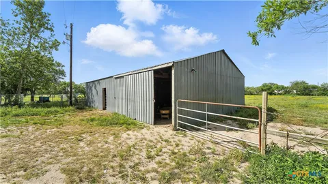a backyard of a house with lots of green space and mountain view in the back