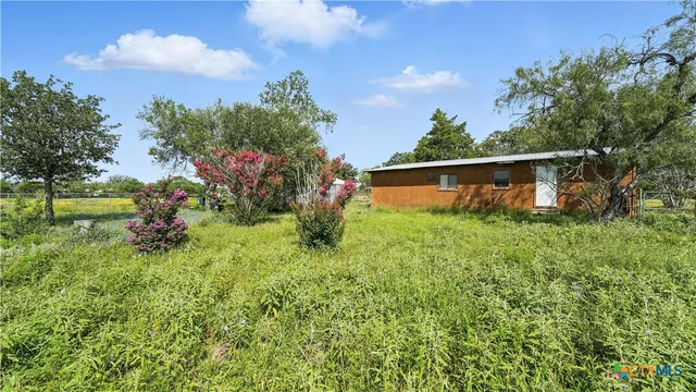 a backyard of a house with lots of green space