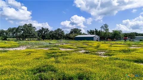 a view of a swimming pool with an outdoor space and seating in back