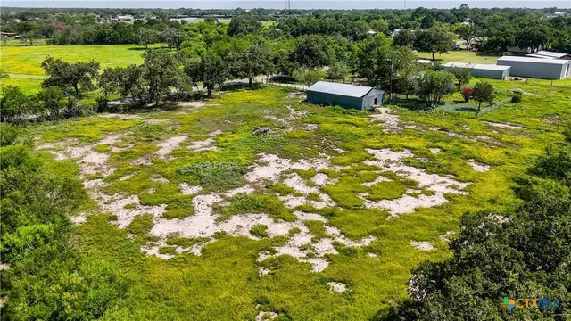 a backyard of a house with a yard and outdoor seating
