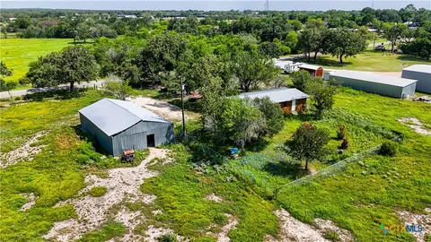 an aerial view of a house with yard swimming pool and outdoor seating