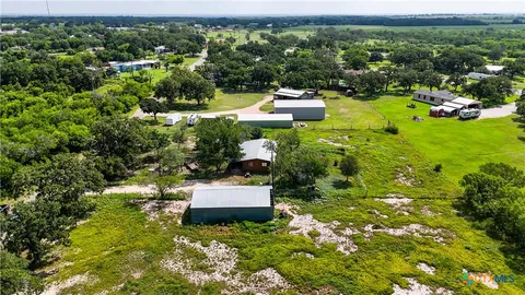 a view of a garden with lawn chairs