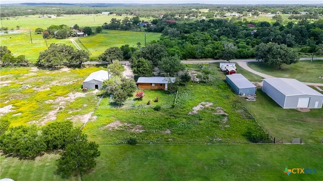 a view of a house with a yard and lake view