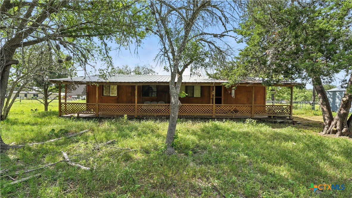 275-279 Cross Road Kingsbury, TX 78638 - Photo 8 of 36 a view of house with yard
