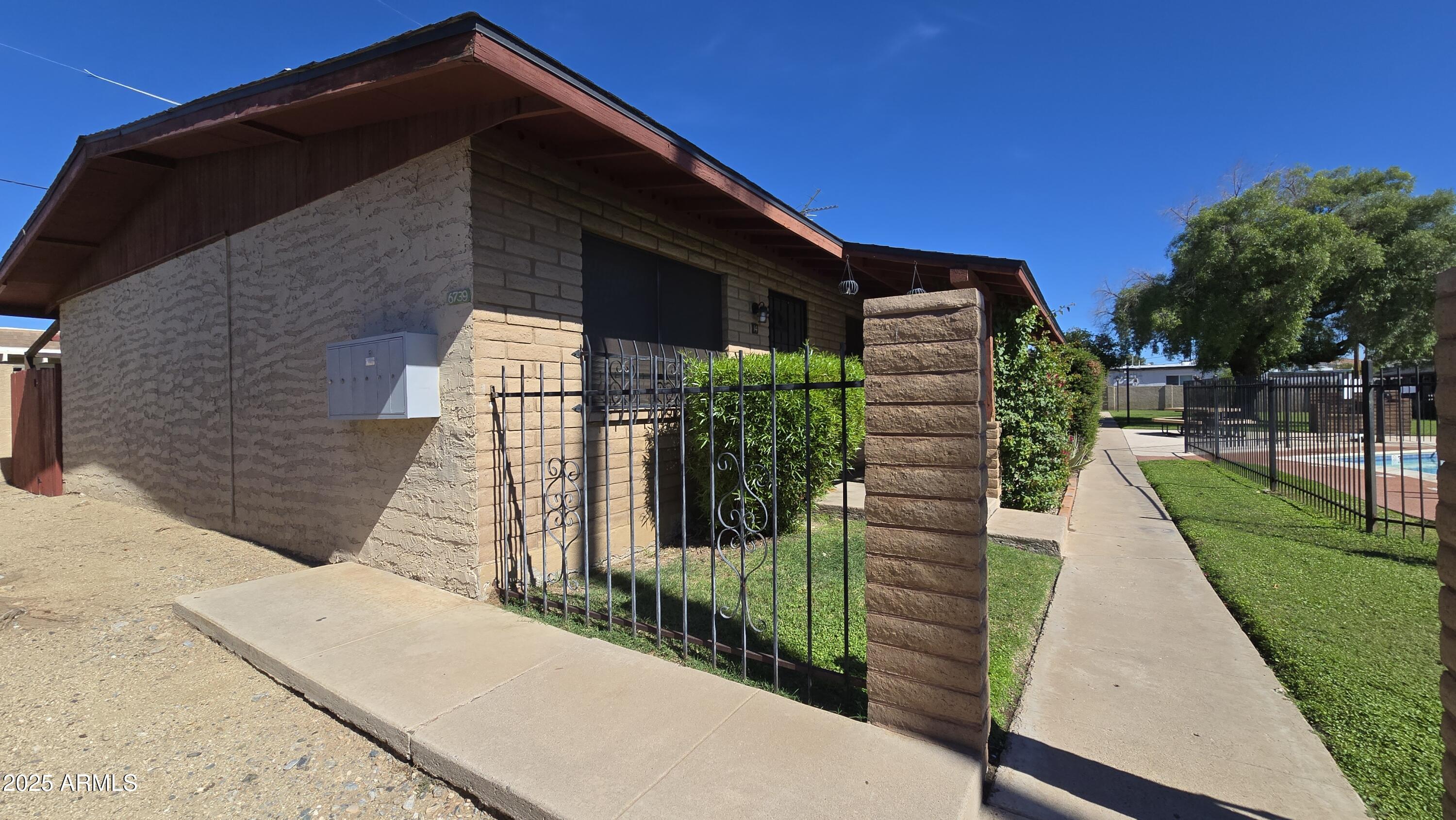 6739 North 16th Street, Unit 14 Phoenix, AZ 85016 - Photo 19 of 19 a pathway of a house with a yard