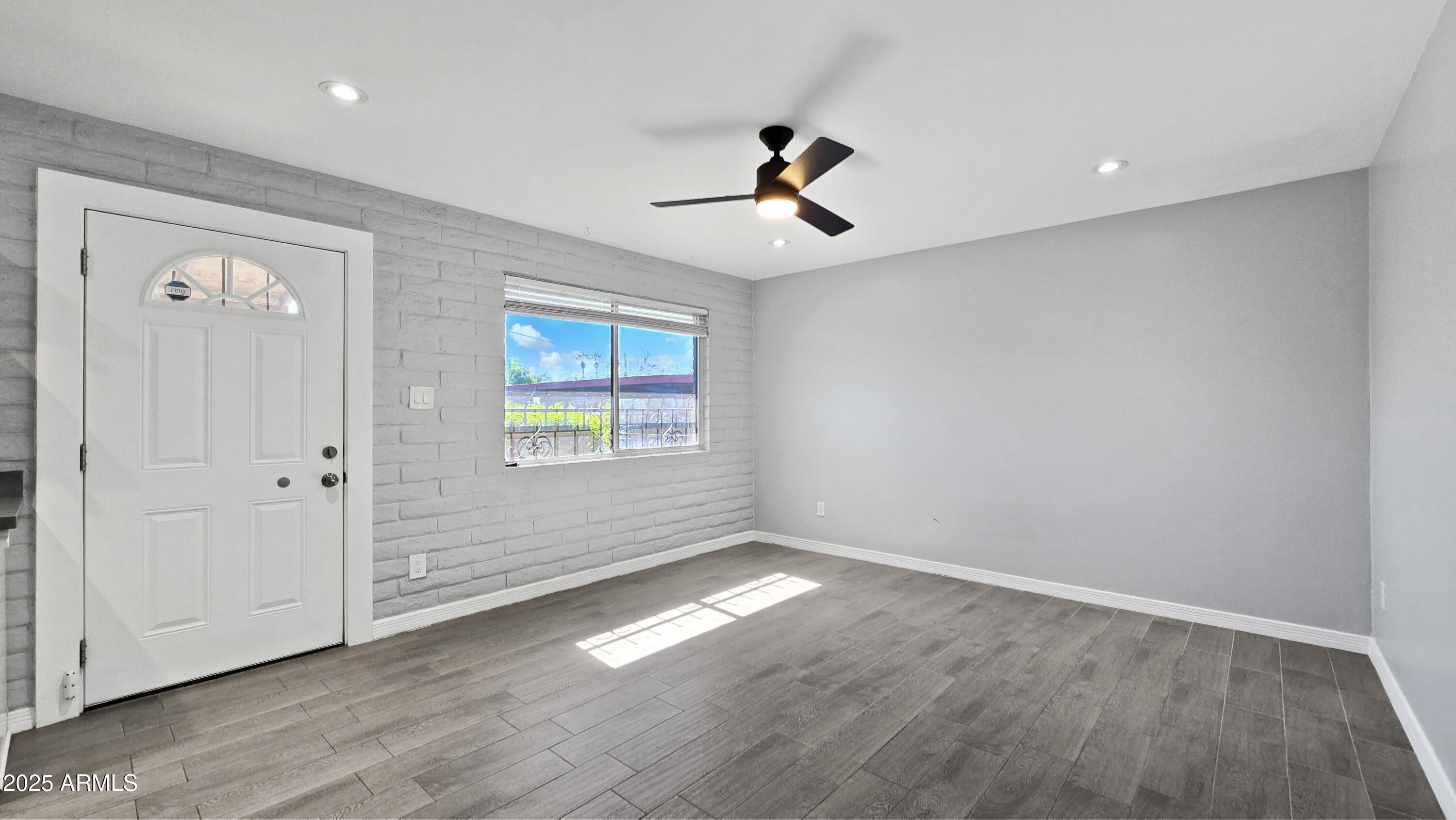 6739 North 16th Street, Unit 14 Phoenix, AZ 85016 - Photo 3 of 19 wooden floor in an empty room with a window