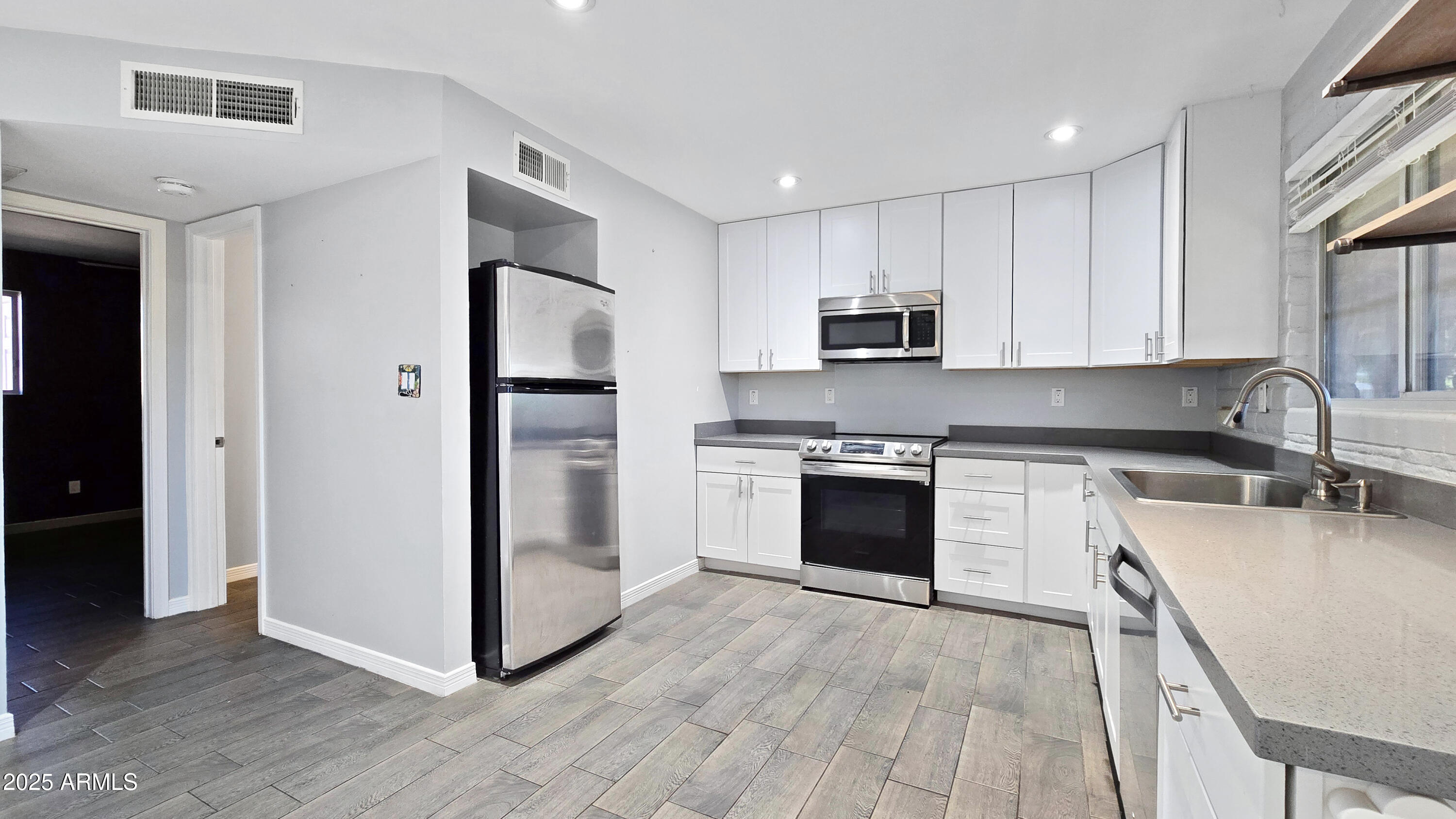 6739 North 16th Street, Unit 14 Phoenix, AZ 85016 - Photo 5 of 19 a kitchen with granite countertop a refrigerator stove top oven and sink