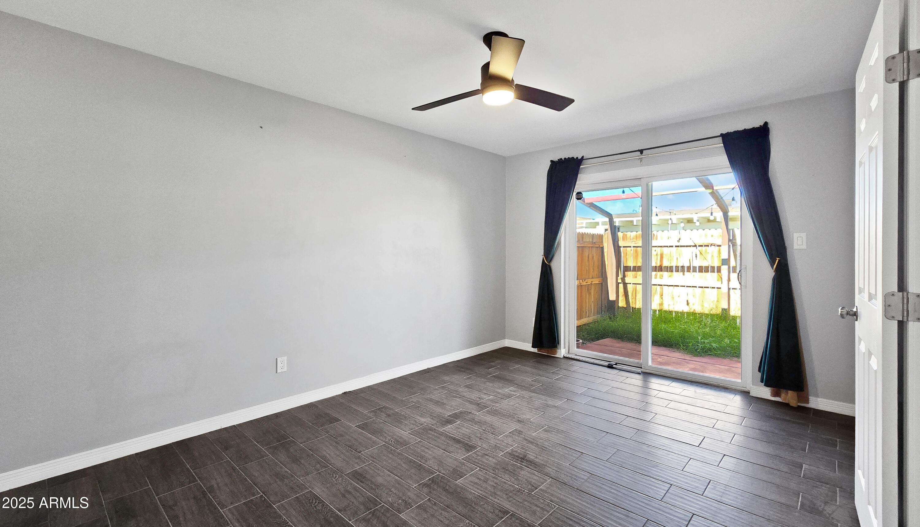 6739 North 16th Street, Unit 14 Phoenix, AZ 85016 - Photo 7 of 19 an empty room with wooden floor and windows