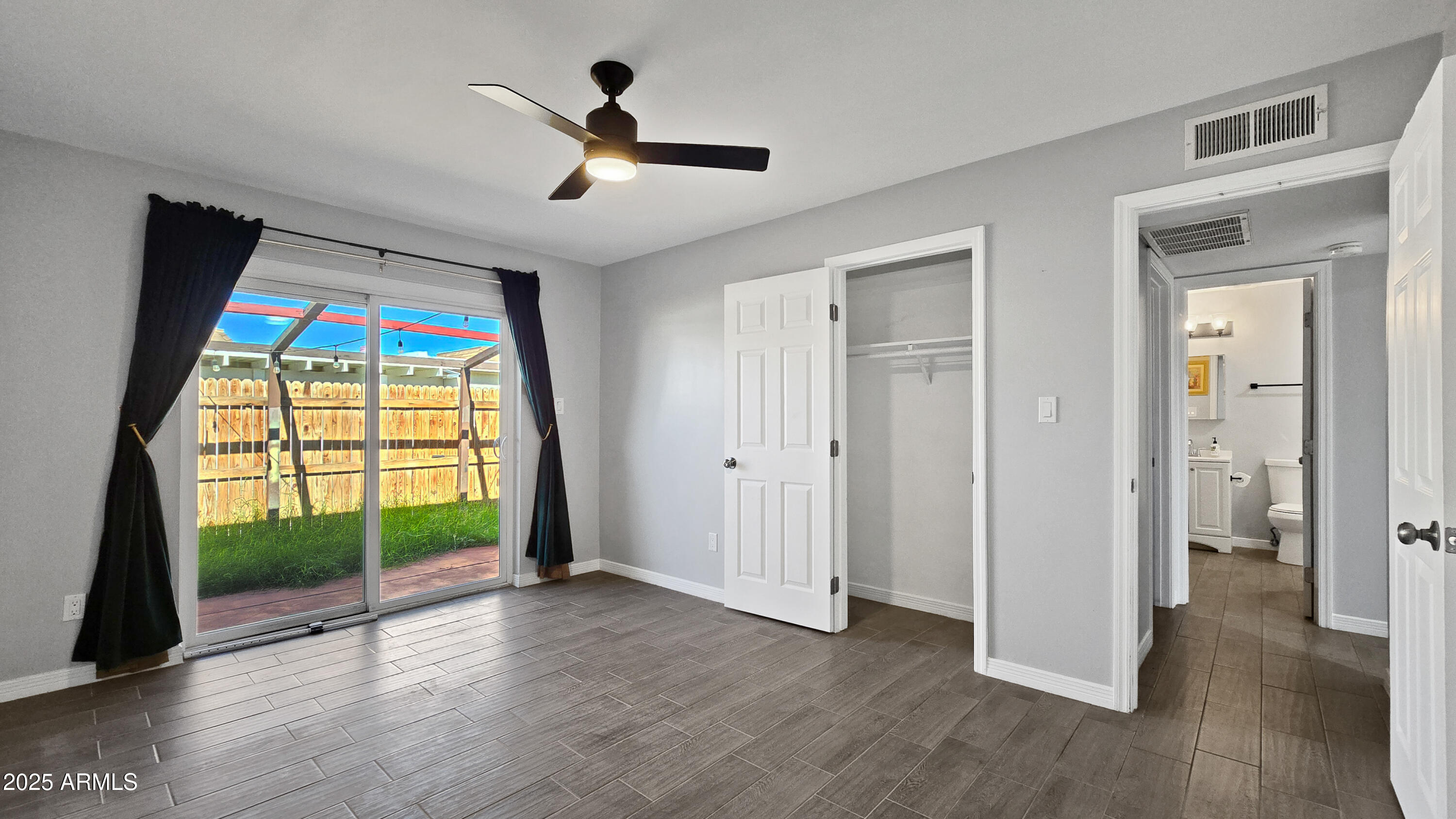 6739 North 16th Street, Unit 14 Phoenix, AZ 85016 - Photo 8 of 19 a view of empty room with wooden floor and fan