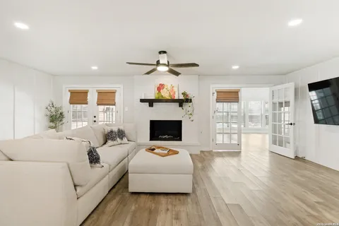 a living room with furniture a fireplace and a flat screen tv