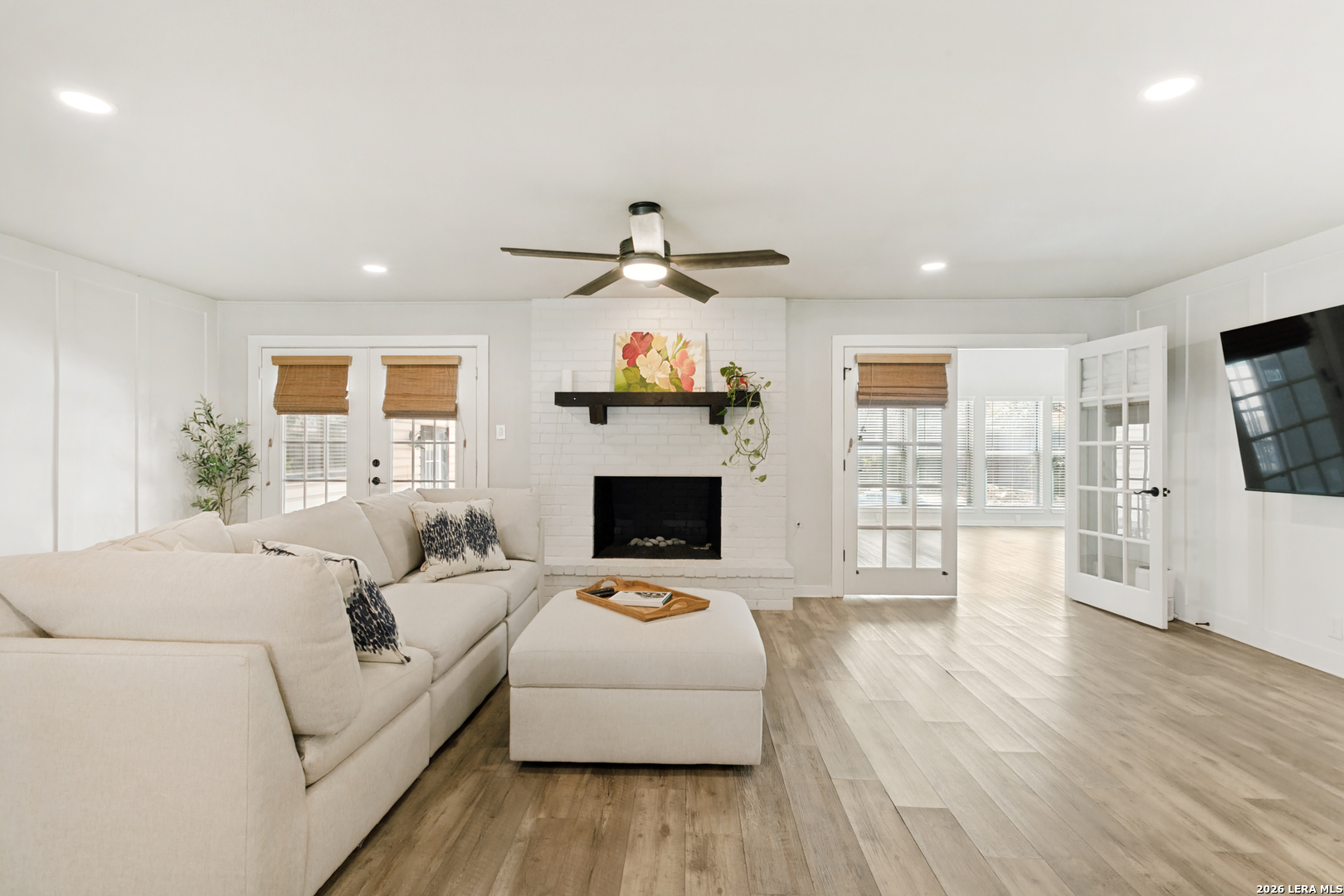 102 Silver Spring Universal City, TX 78148 - Photo 9 of 36 a living room with furniture a fireplace and a flat screen tv