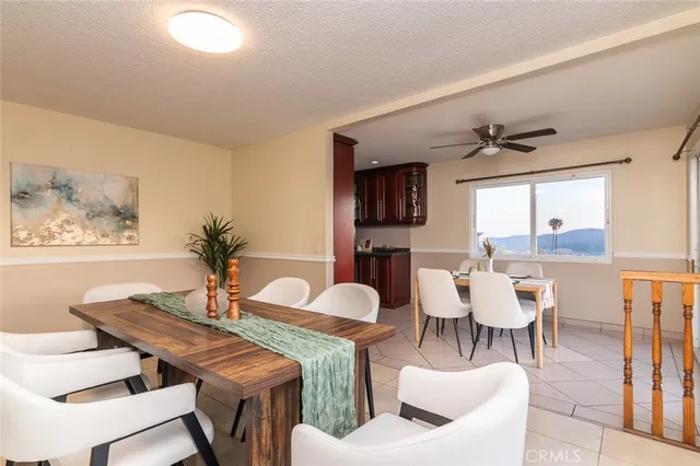 a dining room with furniture and a large window