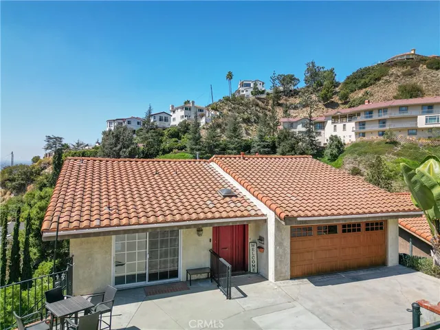 a front view of a house with a garden