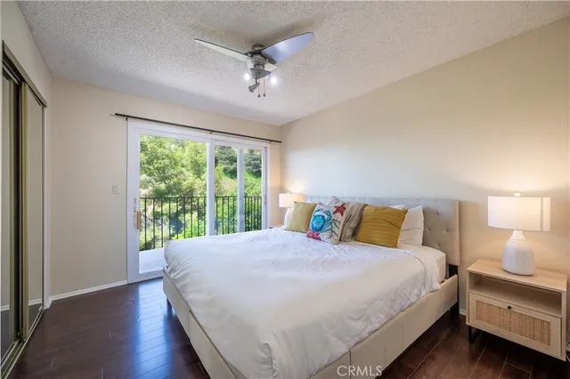 a view of a livingroom with furniture wooden floor a sink and a mirror