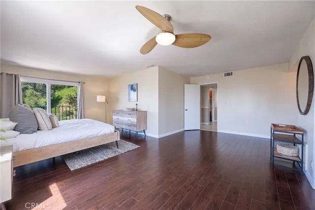 a bedroom with a bed lamp and a window