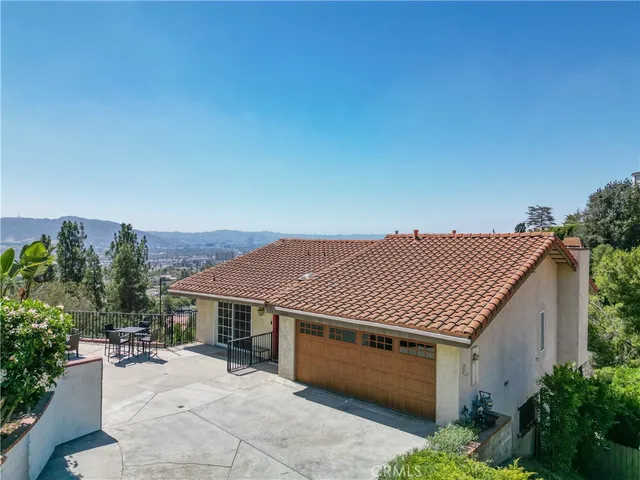 a front view of a house with a garden and plants