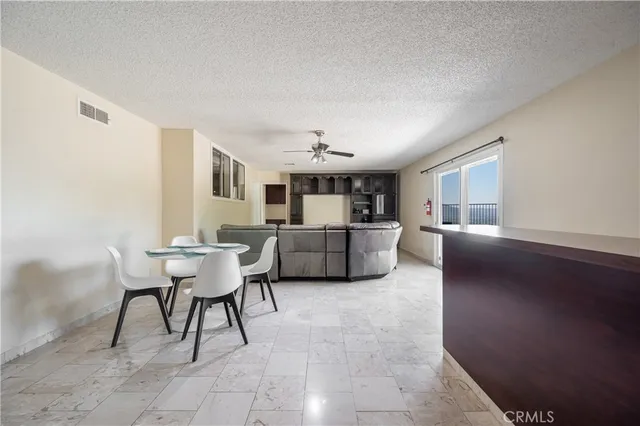 a bedroom with a large bed and a lamp on dresser