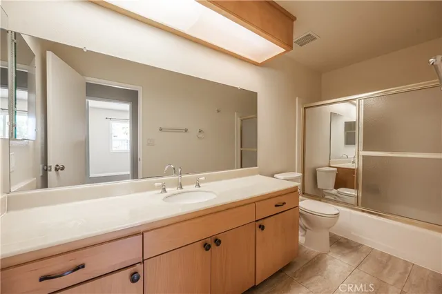 a backyard of a house with fire pit and outdoor seating