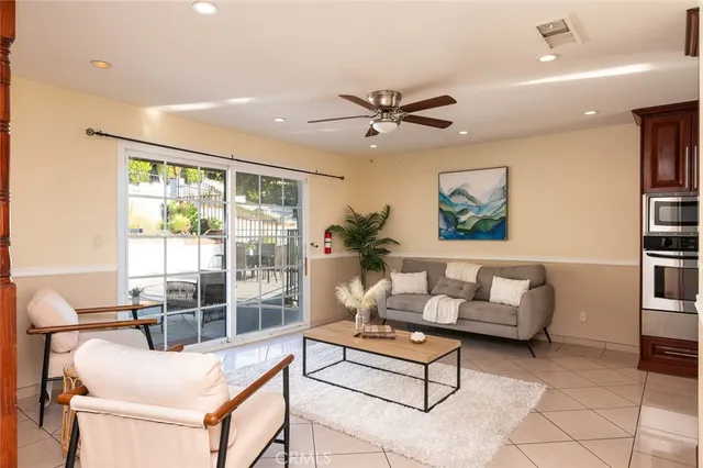 a living room with furniture and a glass door