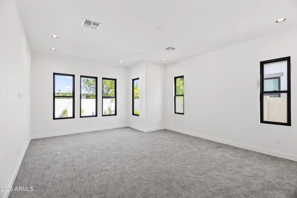 a large bathroom with a granite countertop double vanity sink mirror and shower