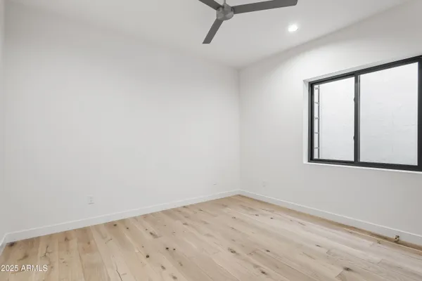 a view of a patio with chairs and a yard with plants