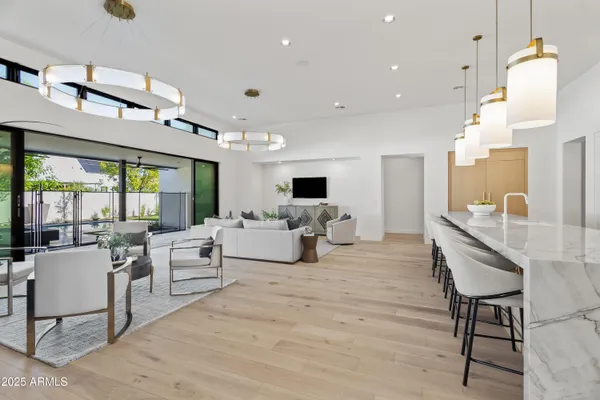 a large kitchen with a table and chairs