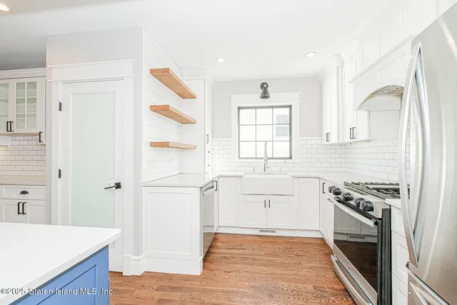a kitchen with a stove a sink and a refrigerator