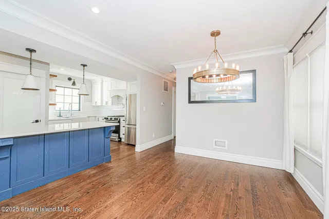 a kitchen with stainless steel appliances granite countertop wooden floors and granite counter tops