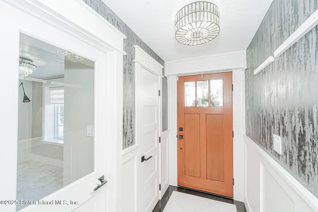 a view of an entryway with wooden floor