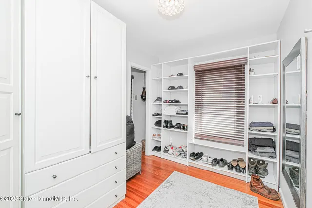 a bedroom with furniture and a window