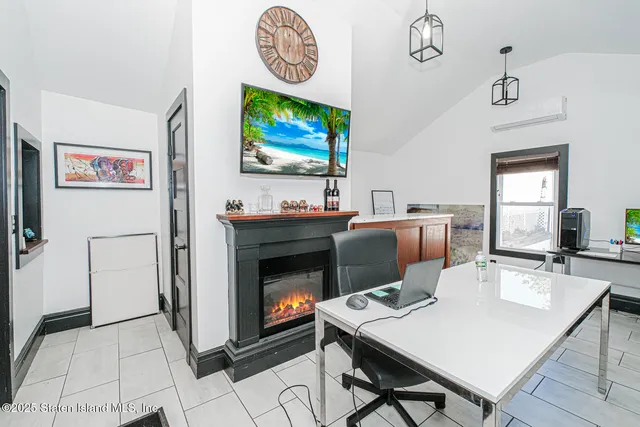 a living room with fireplace furniture and a flat screen tv