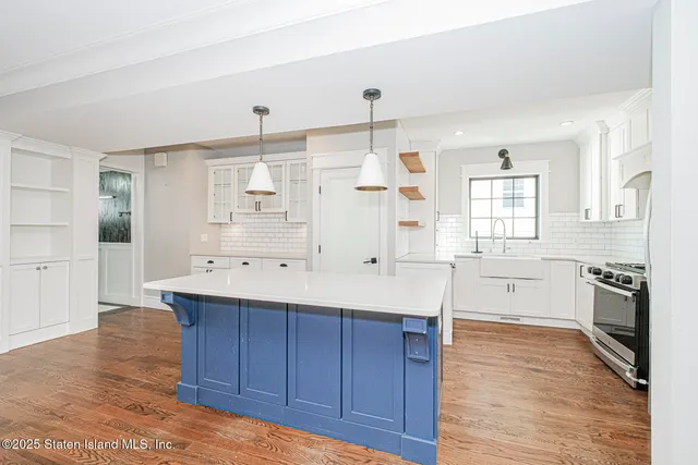 a large kitchen with a stove a sink dishwasher and a refrigerator