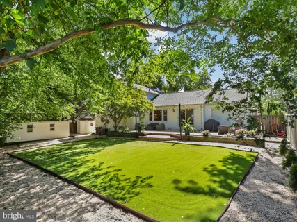 a view of a house with swimming pool and sitting area