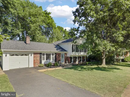 front view of a house with a tree