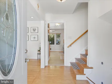 a view of entryway and hall with wooden floor